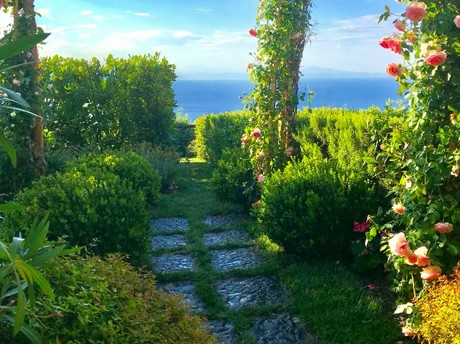 Pergola di rose e percorso con vista sul mare nel giardino di Villa Margherita